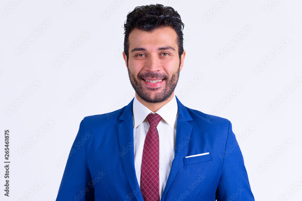 Portrait of happy bearded Persian businessman smiling Portrait of happy bearded Persian businessman smiling