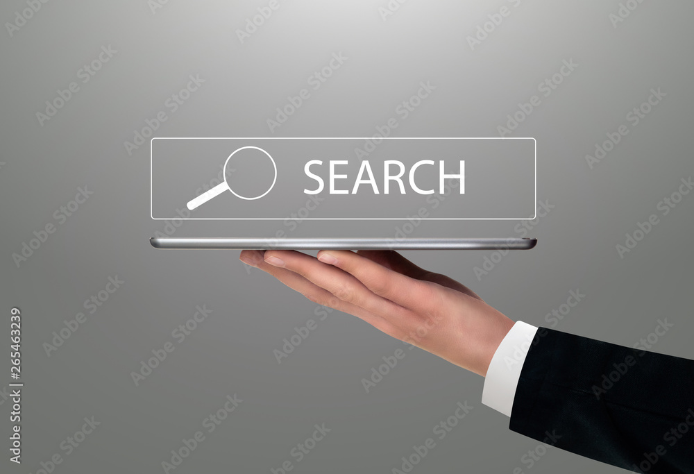 Man holding digital tablet with search symbol Man holding digital tablet with search symbol