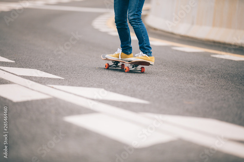 Skateboarder skateboarding on city road
