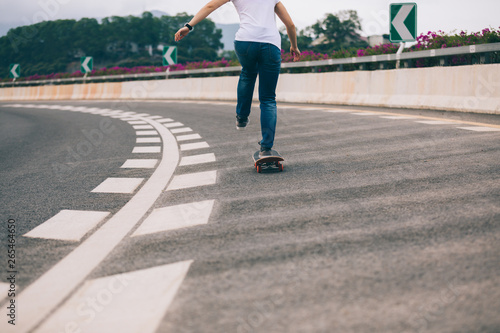 Skateboarder skateboarding on city road