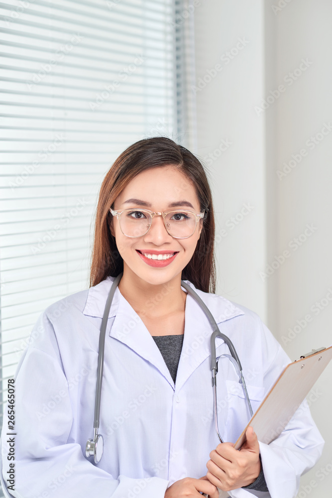 Portrait of smiling female doctor standing posing in her hospital office., Healthcare and medical occupation concept. Portrait of smiling female doctor standing posing in her hospital office., Healthcare and medical occupation concept.