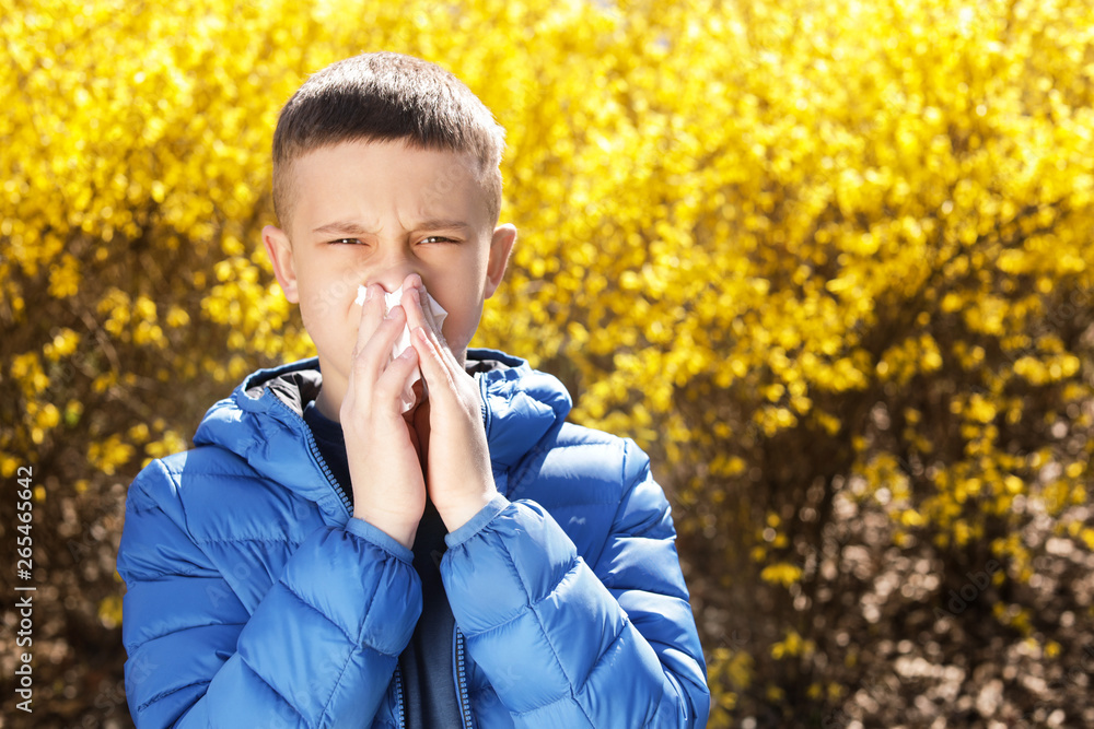 Little boy suffering from seasonal allergy outdoors, space for text Little boy suffering from seasonal allergy outdoors, space for text