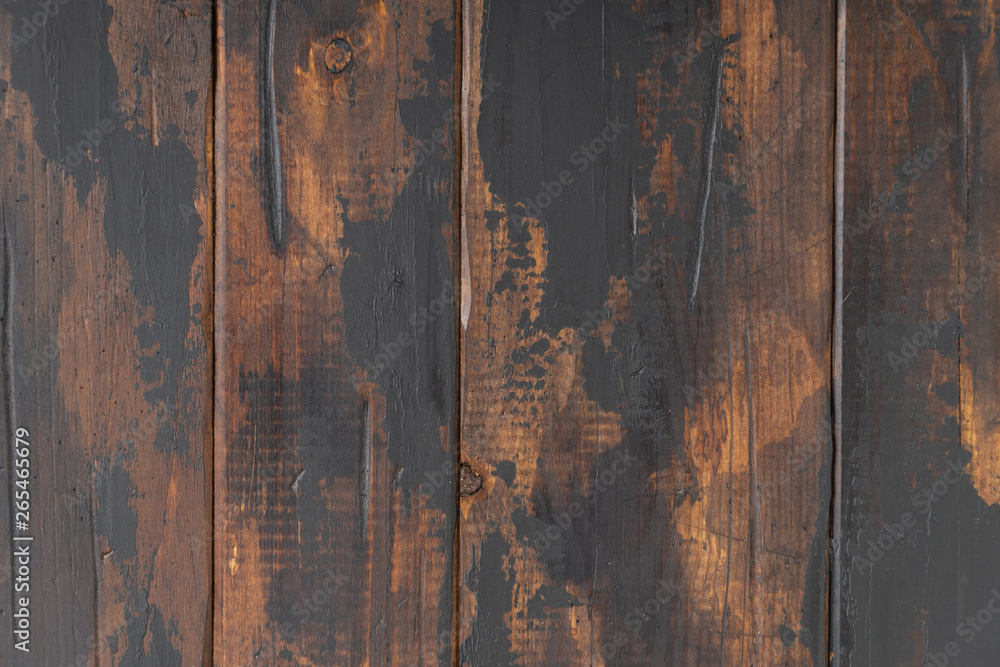 The old wooden surface background, scuffed boards with black paint stains.