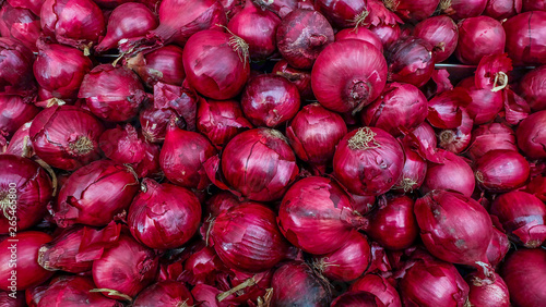 Fresh onions. Onions red background. Ripe onions red. Onions red in market. photo