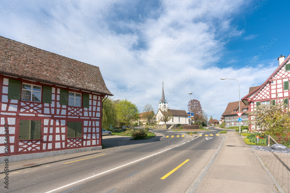 traffic circle intersection in Guettingen framed by historic half-timbered houses and church traffic circle intersection in Guettingen framed by historic half-timbered houses and church