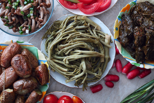 Pickled prickly russian thistle, mushrooms, baked potato, tolma. Pickled tumbleweed, tolma, dolma, baked potato, marinated mushrooms, vegetables photo