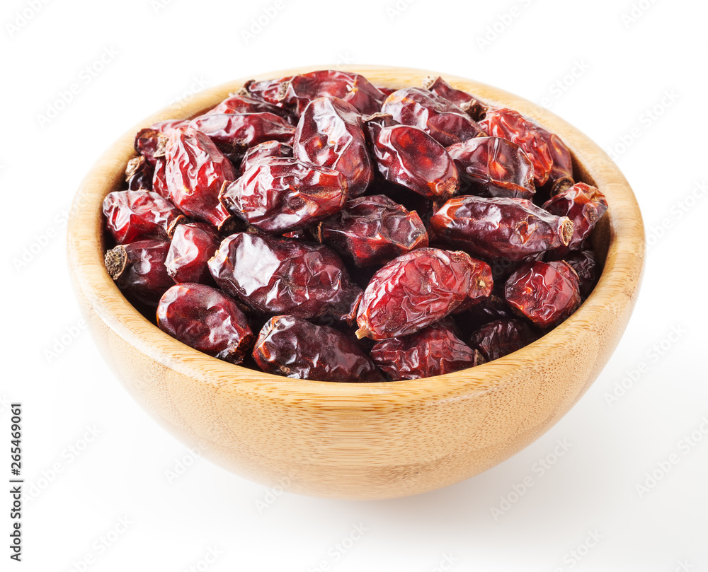 Dried wild rose berries in wooden bowl isolated on white background with clipping path Dried wild rose berries in wooden bowl isolated on white background with clipping path