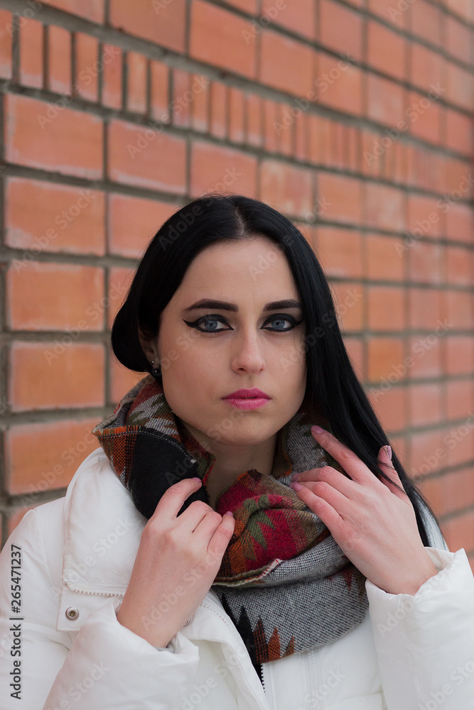 Naklejka premium beautiful young brunette walks in the winter park