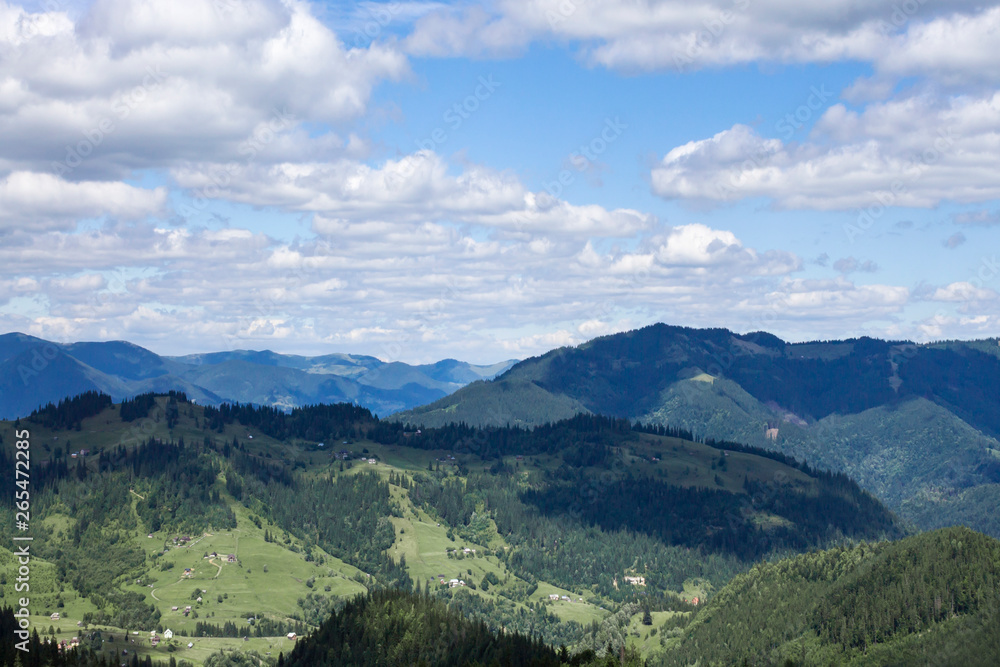 Obraz premium Scenic summer or spring mountain view with cloudy sky. Ukraine, Carpathians, Dzembronia High mountains in vivid color. Nobody. Beautiful mountain lanscape or valley.