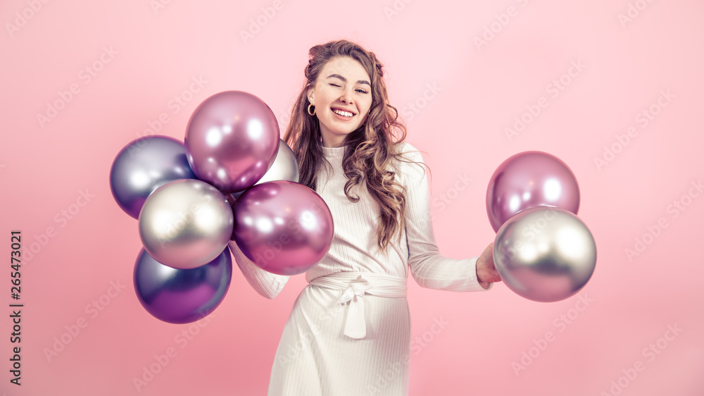 Young girl with balls on a colored background Young girl with balls on a colored background