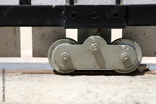 Wheel of sliding door in front of house. Steel wheels of sliding doors.