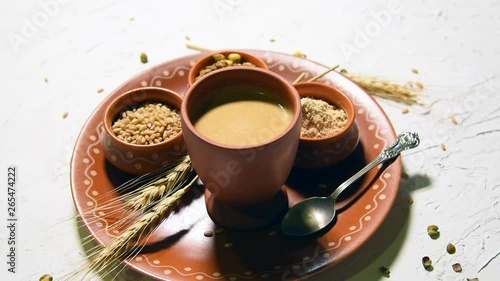 Sattu sharbat is a cooling sweet drink made in summer with roasted black chickpea flour, barley, suger, salt & water. served in a glass. selective focus photo