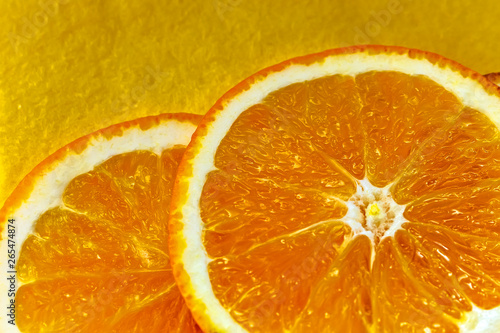 slice of orange on a yellow background