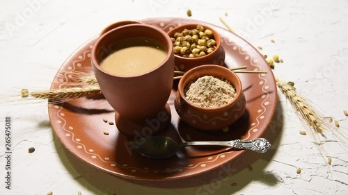 Sattu sharbat is a cooling sweet drink made in summer with roasted black chickpea flour, barley, suger, salt & water. served in a glass. selective focus photo