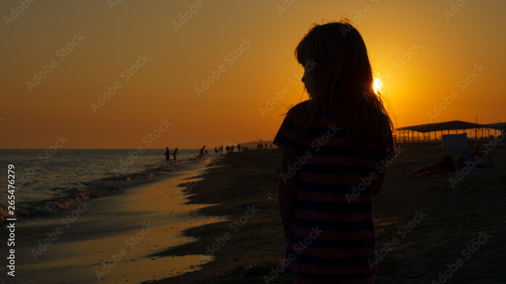 Portrait in the background light at sunset by the sea