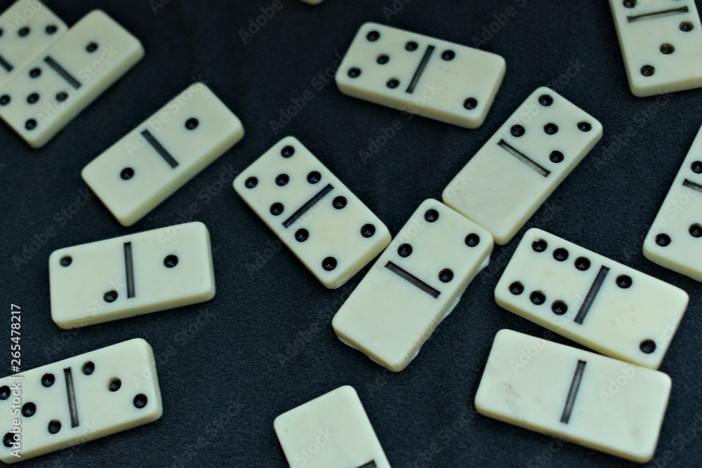 Some dominoes pieces thrown on a black background Some dominoes pieces thrown on a black background