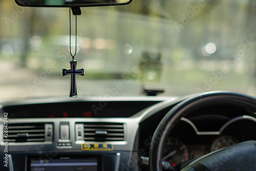 Cross hanging from rear view mirror