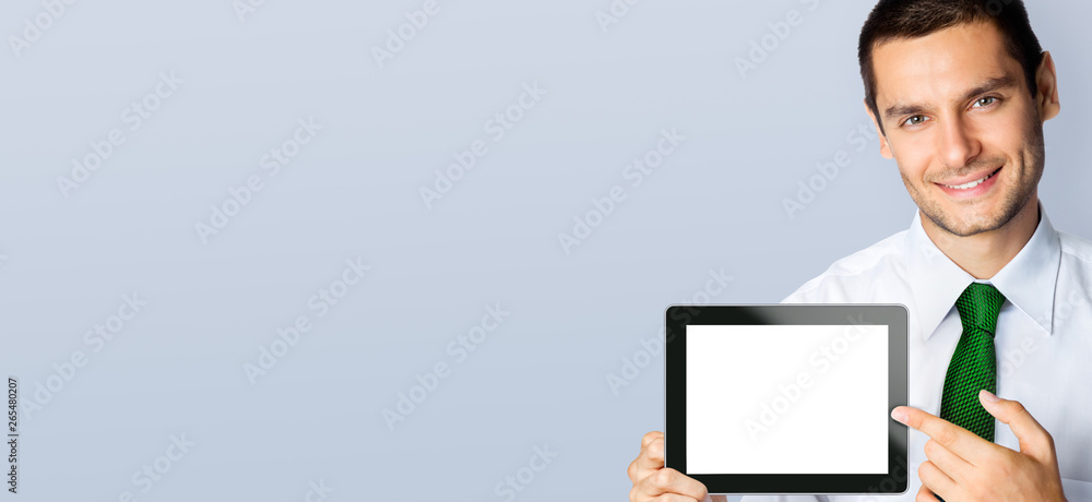 Businessman showing blank tablet pc, with copy space Businessman showing blank tablet pc, with copy space