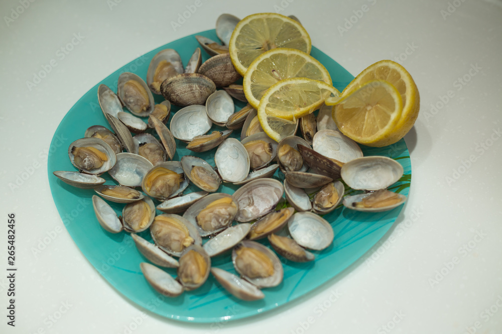 Delicious clam Spisula lies on the foil for cooking in the oven, the fire Delicious clam Spisula lies on the foil for cooking in the oven, the fire