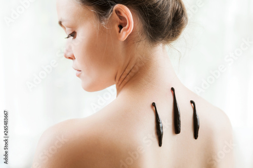 The girl with bloodsuckers on a back on a white background.