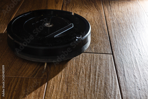 Robotic vacuum cleaner on laminate wood floor smart cleaning technology
