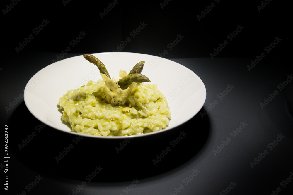Risotto with asparagus decorated with cheese waffle Risotto with asparagus decorated with cheese waffle