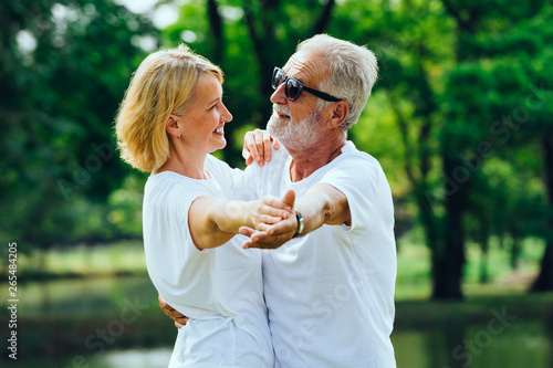 Caucasian  Elderly man and woman  happy  smiling dancing  in the park
