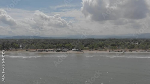Aerial view of ocean waves crashing on Beautiful beach by, 4K drone footage at Sabandar Beach, Tuaran, Sabah, Malaysia photo