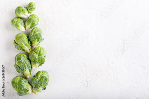 Fresh raw organic brussels sprouts on white background. Top view, flat lay, copy space. photo