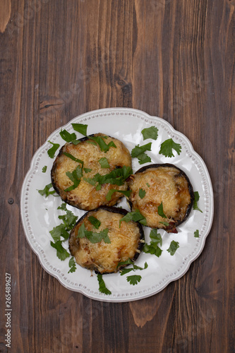 stuffed mushrooms with cheese and herbs on white beautiful dish