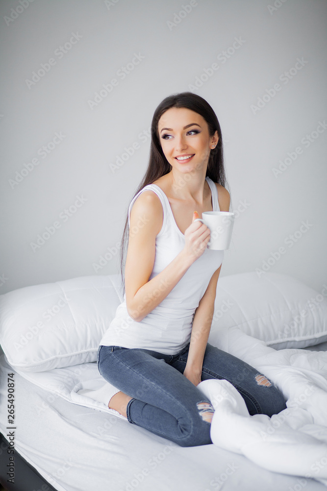 Relaxing On Bed During Weekend. Beautiful Woman Relaxing on a Bed and Looking Happy Relaxing On Bed During Weekend. Beautiful Woman Relaxing on a Bed and Looking Happy