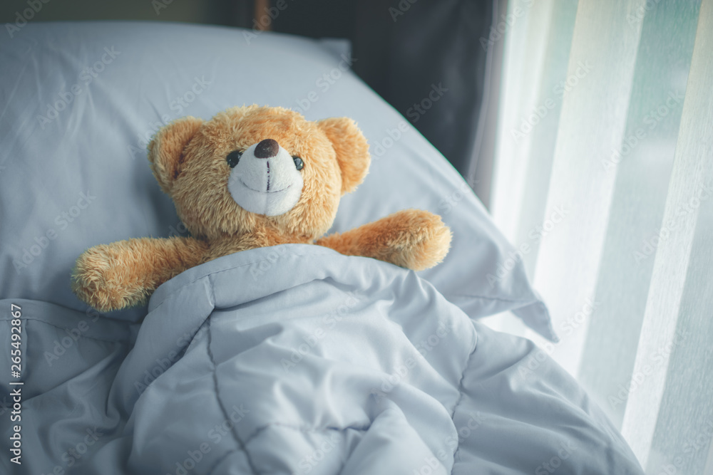 couple love bear doll lying on bed room, feel like happy and low key. soft focus.