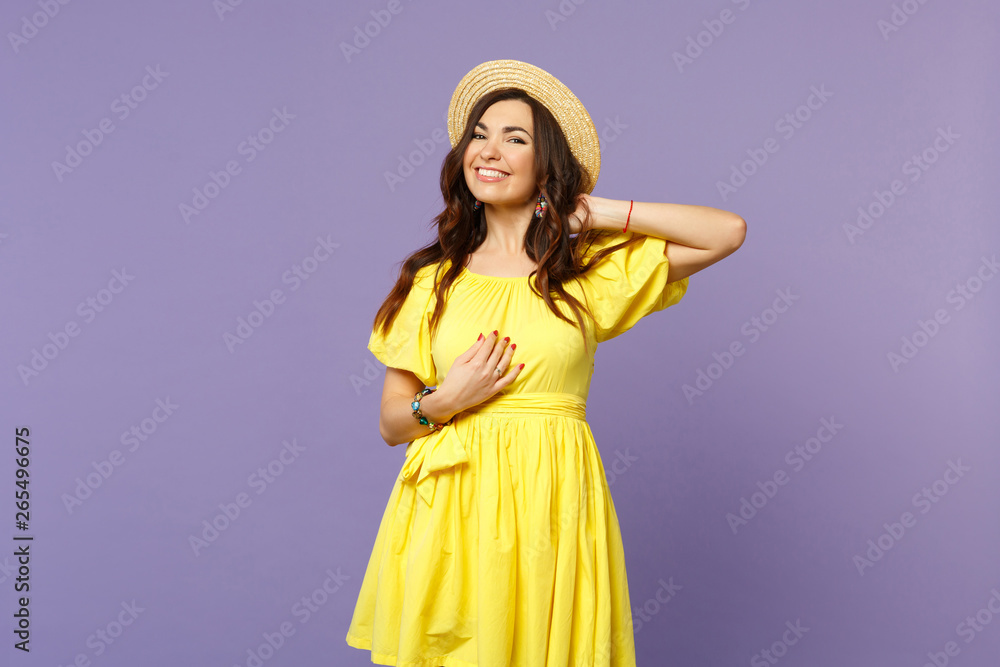 Portrait of charming smiling young woman in yellow dress, summer hat looking camera isolated on pastel violet wall background in studio. People sincere emotions, lifestyle concept. Mock up copy space. Portrait of charming smiling young woman in yellow dress, summer hat looking camera isolated on pastel violet wall background in studio. People sincere emotions, lifestyle concept. Mock up copy space.