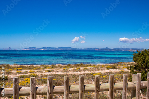 Typical balearic natural reserve wooden fence  and blue mediterranean sea on the background  Formentera Island  Spain