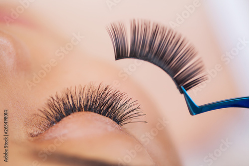 Woman Eye with Long Eyelashes. Beautiful Young Woman During Eyelash Extension