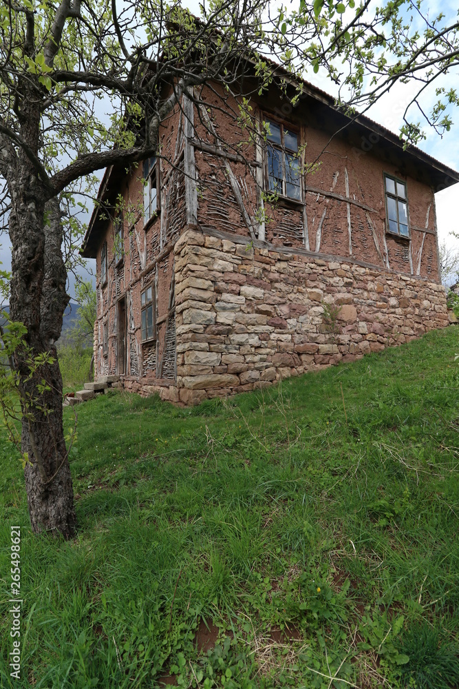 Old ruined house adobe and wood facade in village Gara Bov, Bulgaria. Old adobe wall. Brown, detail. Old ruined house adobe and wood facade in village Gara Bov, Bulgaria. Old adobe wall. Brown, detail.