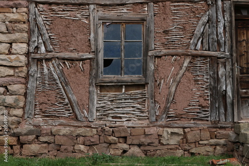 Old ruined house adobe and wood facade in village Gara Bov, Bulgaria. Old adobe wall. Brown, detail. photo