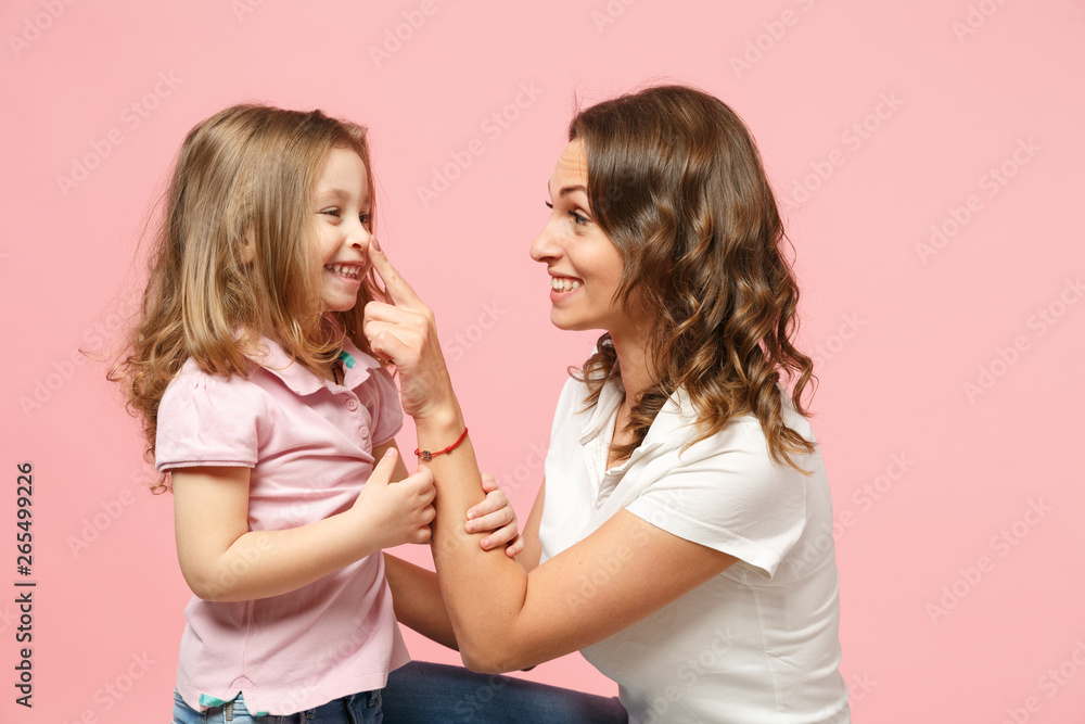 Woman in light clothes have fun with cute child baby girl. Mother, little kid daughter isolated on pastel pink wall background, studio portrait. Mother's Day, love family, parenthood childhood concept Woman in light clothes have fun with cute child baby girl. Mother, little kid daughter isolated on pastel pink wall background, studio portrait. Mother's Day, love family, parenthood childhood concept