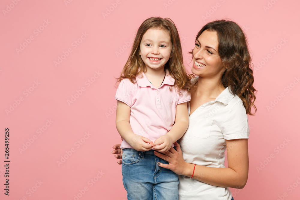 Woman in light clothes have fun with cute child baby girl. Mother, little kid daughter isolated on pastel pink wall background, studio portrait. Mother's Day, love family, parenthood childhood concept Woman in light clothes have fun with cute child baby girl. Mother, little kid daughter isolated on pastel pink wall background, studio portrait. Mother's Day, love family, parenthood childhood concept