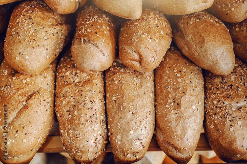 Close up of fresh baked roll on shelve ready to eat. Bakehouse interior.