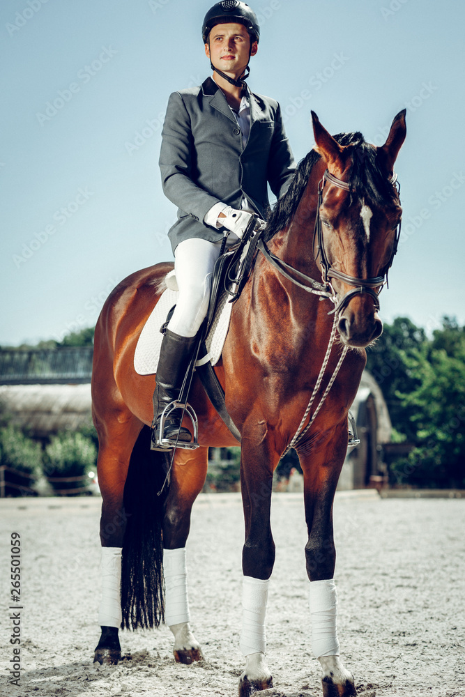 Handsome nice man wearing special uniform for riding Handsome nice man wearing special uniform for riding