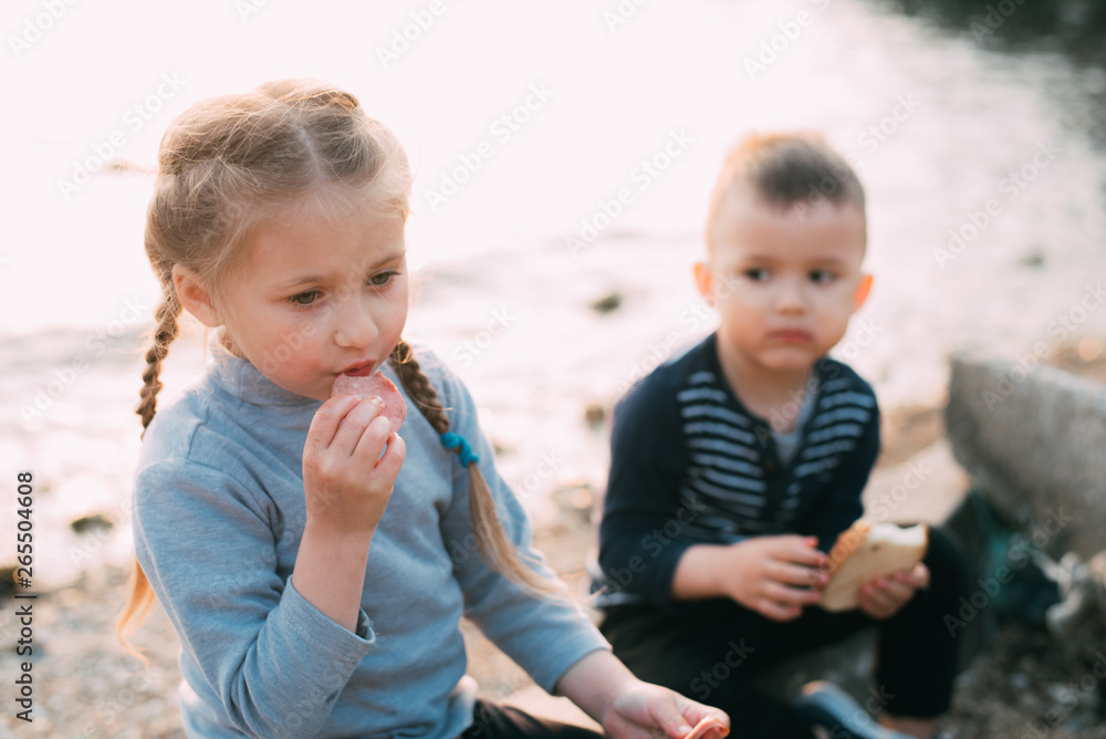 children of the sea girl eating sausage and bread boy children of the sea girl eating sausage and bread boy