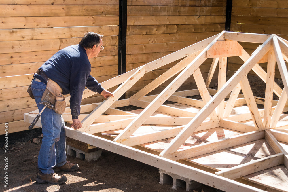 carpenter working on wood structure carpenter working on wood structure