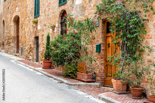 San Quirico D'Orcia, Italy Street empty road in small historic medieval town village in Tuscany during summer day stone architecture and garden