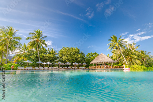 Fototapeta Naklejka Na Ścianę i Meble -  Luxury swimming pool in the tropical hotel or resort. Palm trees and infinity pool close to lounge chairs and umbrellas. Exotic travel destination, summer mood, beach holiday