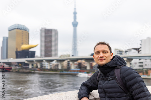 Photography Tokyo, Japan Sumida district area cityscape skyline with young tourist man leani