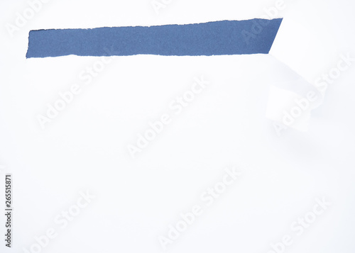 Torn white paper isolated on blue