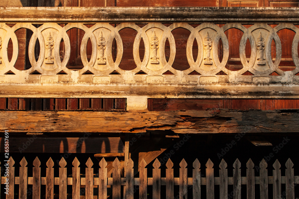 Ancient stucco buddha image on a balcony.