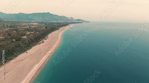 Wallpaper Mural Aerial dolly view of a beach on the East coast of Sicily with the town of Taormina on the background Torontodigital.ca