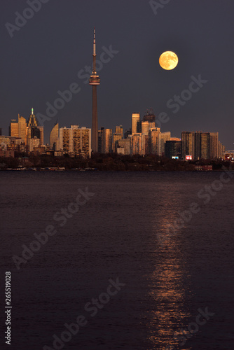 Photography Red supermoon reflected in Lake Ontario rising over Toronto cityscape November 1